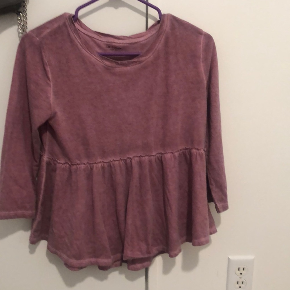 A pink ruffled blouse